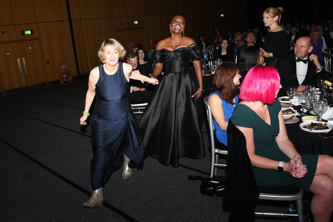 Team of colleagues collecting an award at a corporate evening gala photo
