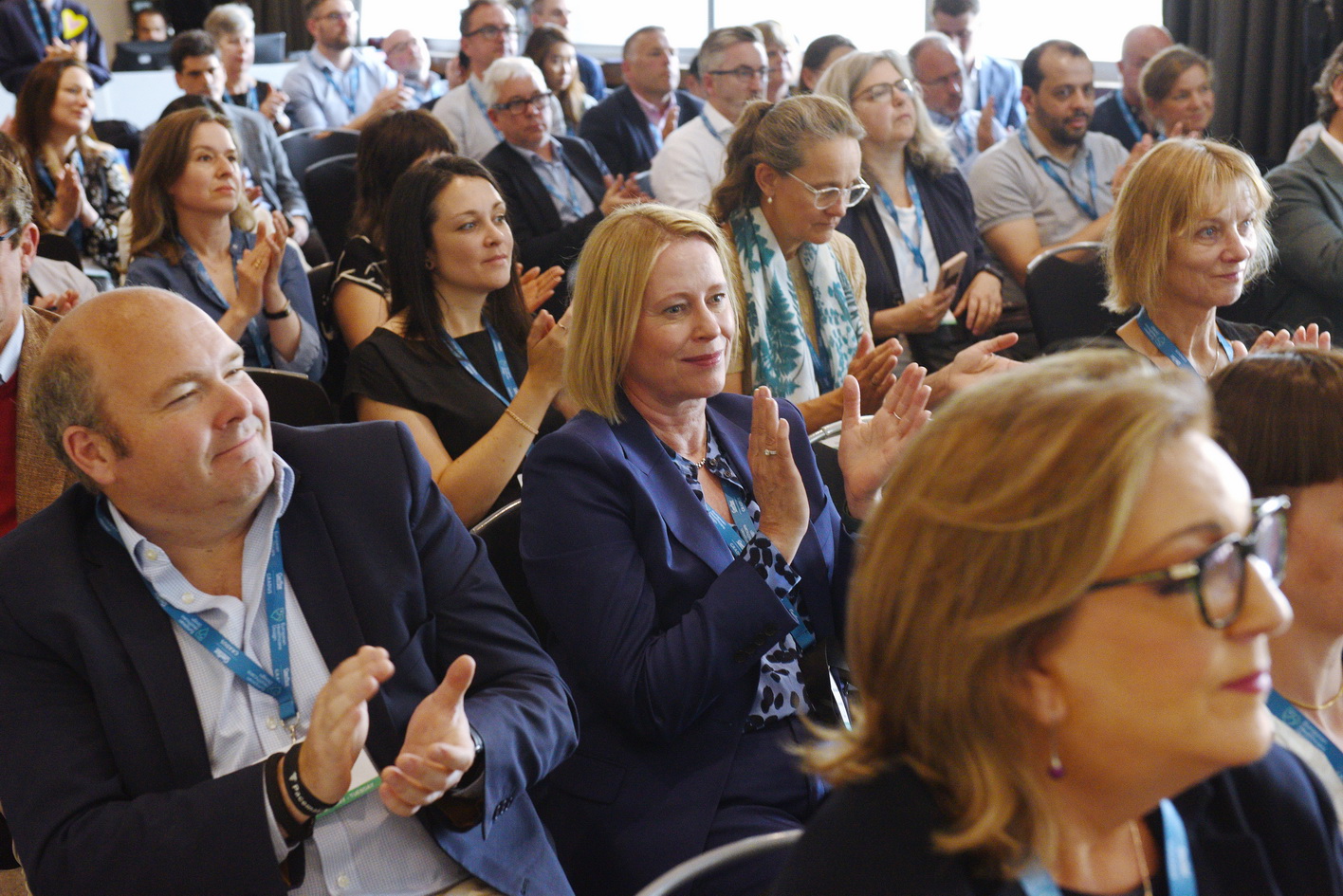 Audience clapping during a keynote session