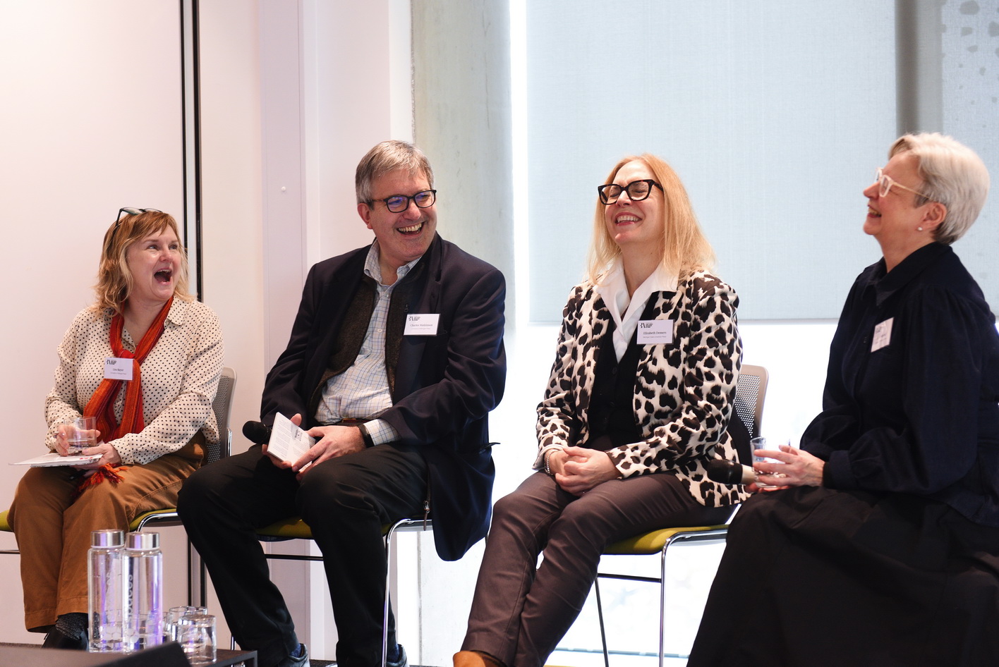 Panel laughing at conference