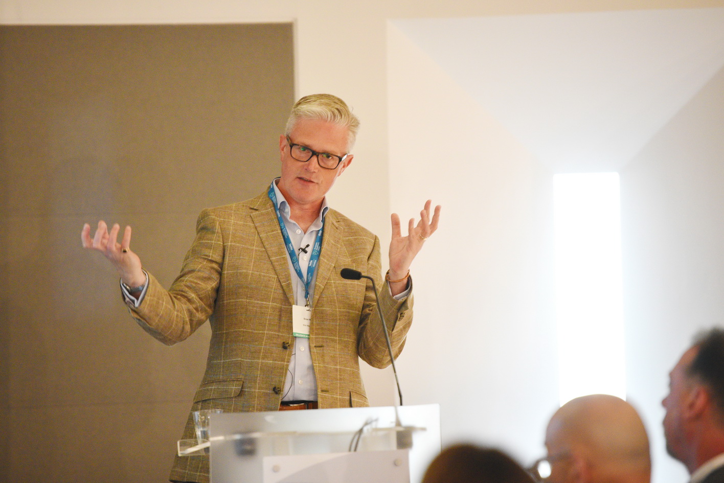 Event presenter speaking to an audience at conference